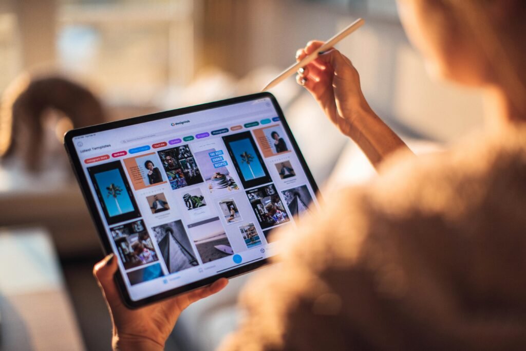pexels photo 3082341 3082341 A person uses a digital tablet with a stylus indoors in a warm, cozy setting.